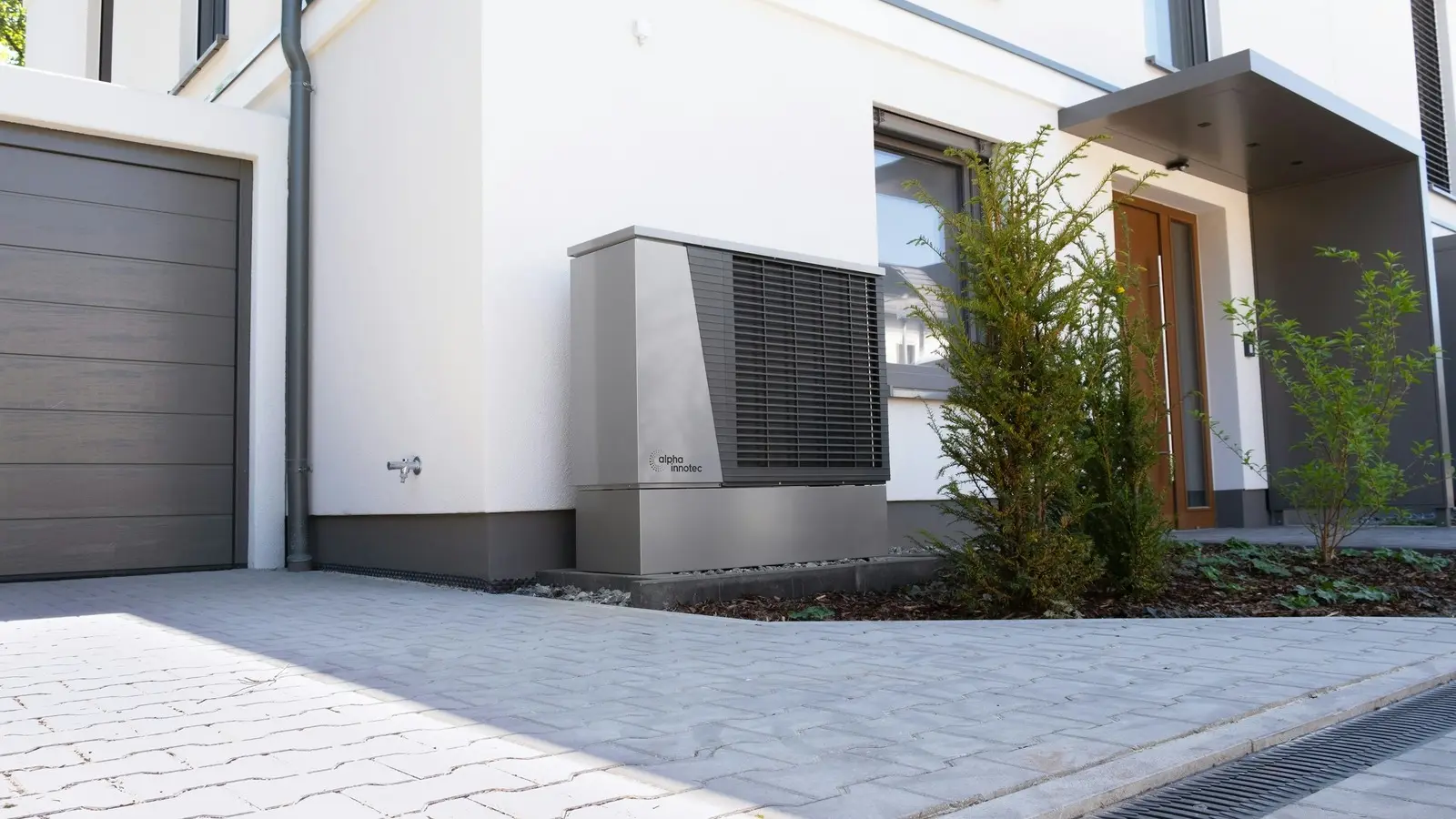 Outdoor heat pump unit installed beside a modern home